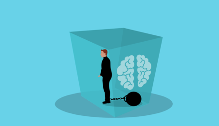 pessoa com uma bola acorrentada na perna dentro de uma caixa com um cérebro