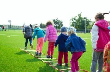 crianças fazendo corrida de obstáculos ao ar livre